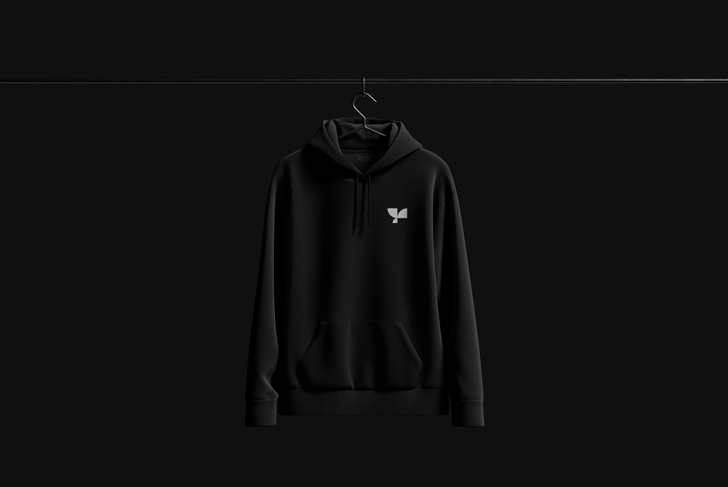 Black hoodie mockup on hanger in minimalist setting, ideal for showcasing apparel designs and branding for designers. High-quality graphic template.