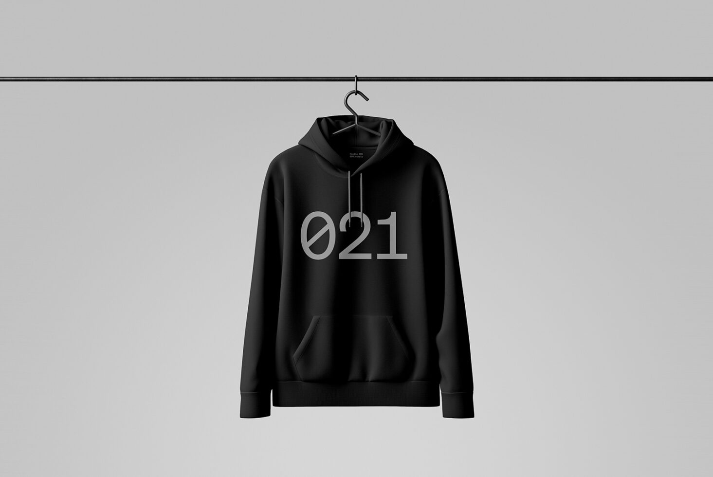 Black hoodie mockup with minimalist design 021 hanging on a rail against a neutral background perfect for fashion branding and graphic design templates.