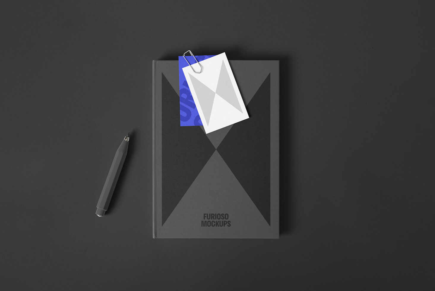 Dark themed notebook mockup with geometric design, paper clip attachment and pen on black surface, ideal for project presentation. Mockups SEO keywords.