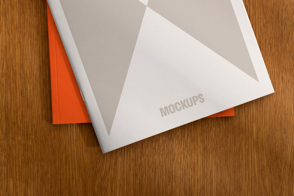 Top view of a mockup magazine with geometric cover design placed on a wooden surface ideal for designers seeking professional presentation templates.