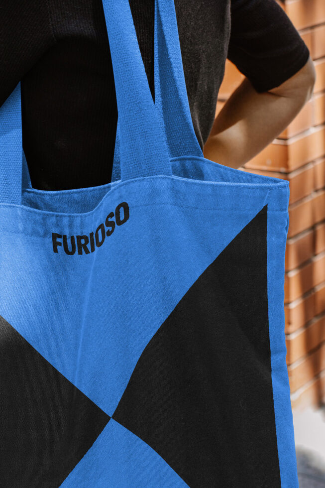 Designer tote bag with bold blue and black geometric pattern, featuring the word Furioso. Ideal for mockups and graphic design projects.