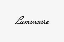 Luminaire script typeface in flowing black italics on light background