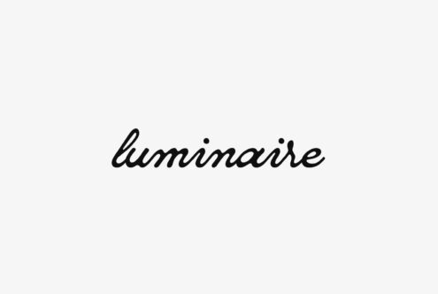 Cursive font spelling luminaire on a white background perfect for designers creating logos banners or digital projects in need of elegant typography graphics