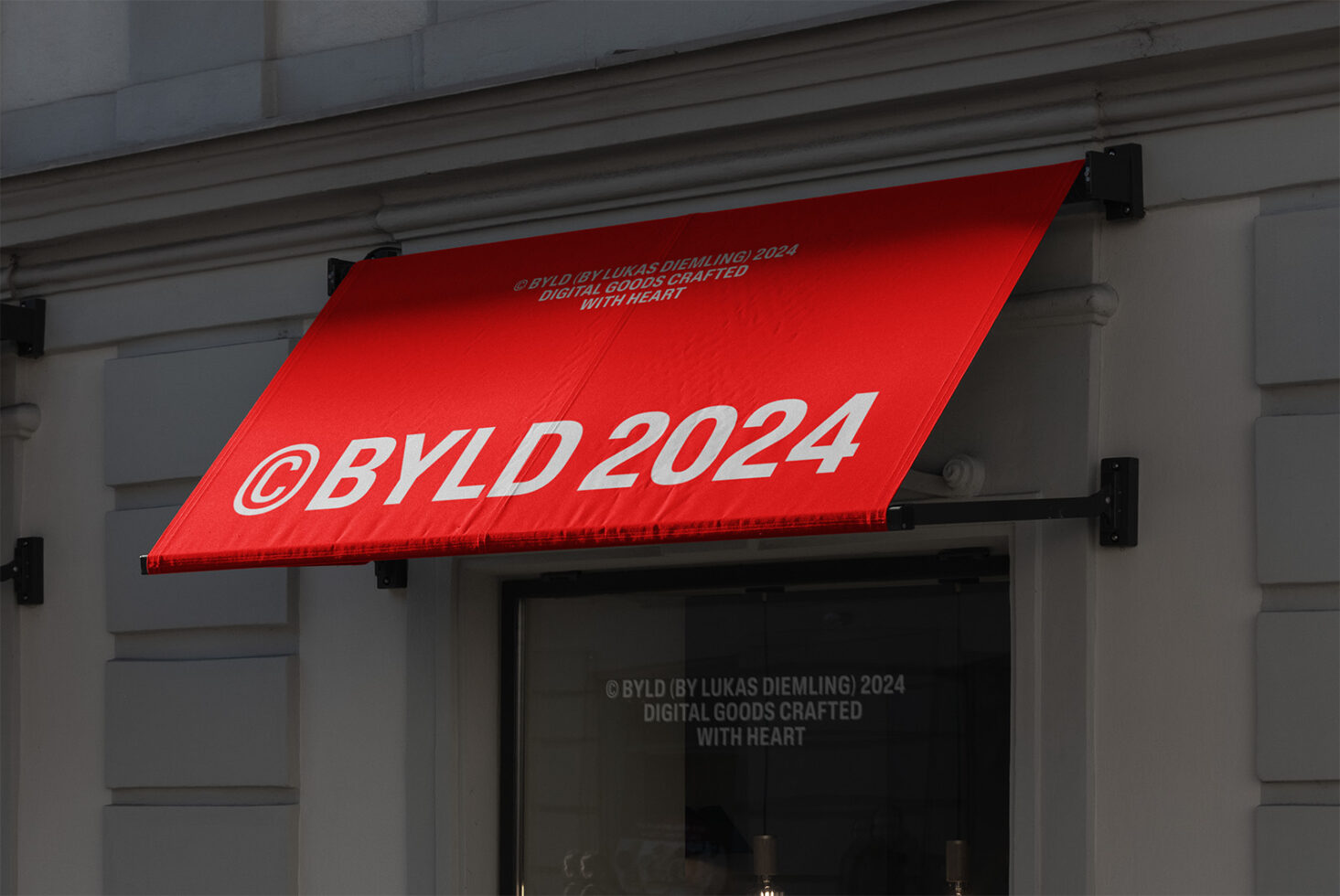 Red storefront awning with bold white text BYLD 2024 suitable for mockup purposes in design projects featuring branding and storefront ideas.