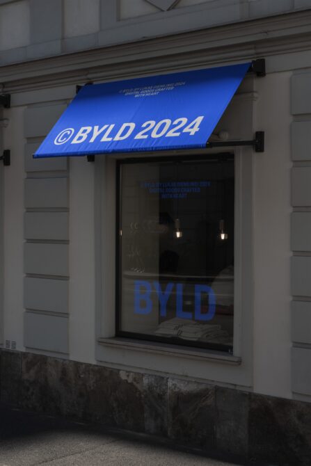 Storefront with blue awning displaying text BYLD 2024 perfect for branding mockups templates or showcasing digital design assets exterior architecture.