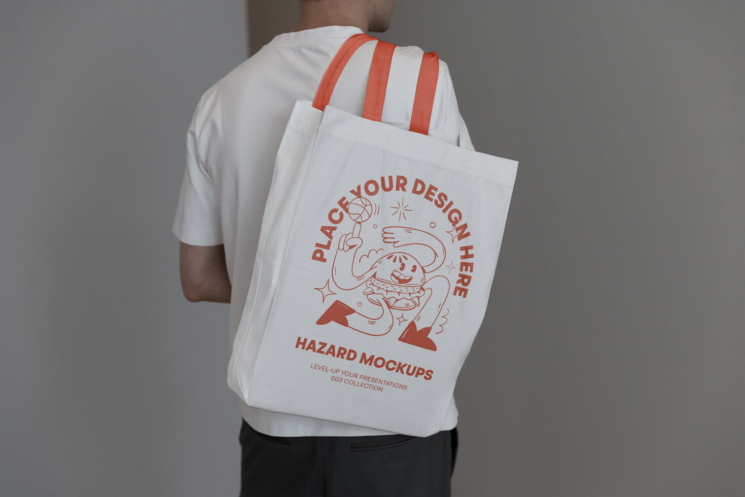 Man holding a customizable tote bag mockup with playful design elements. Perfect for designers seeking graphics and templates for branding projects.