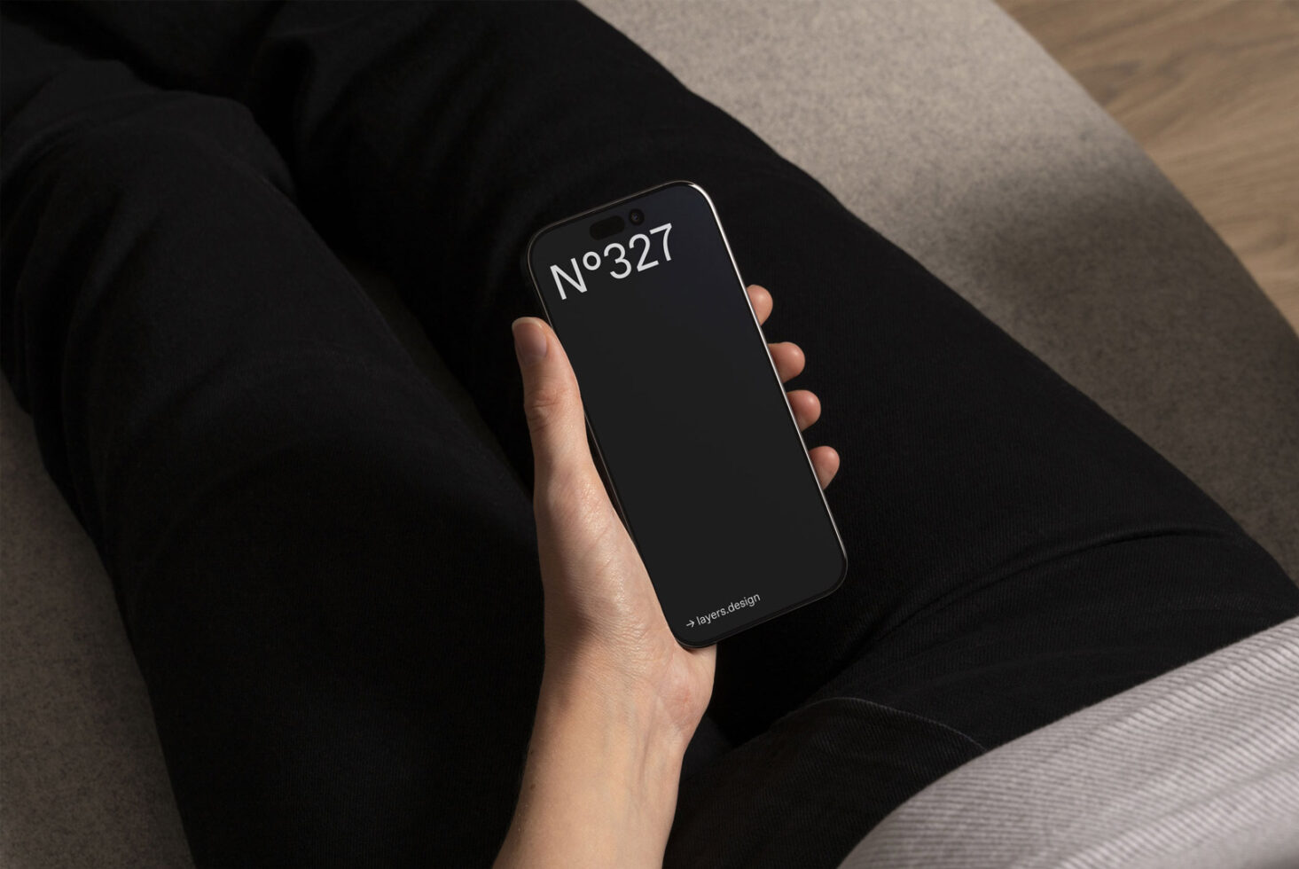 Person holding smartphone with black screen displaying No. 327. Ideal for mobile app mockup. Keywords: smartphone, mockup, design, template, digital asset.