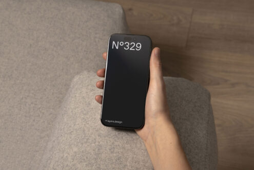 Person holding smartphone featuring minimalist mockup design with number 329 on screen. Ideal for designers seeking mobile UI templates and graphics.