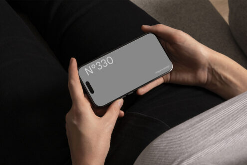 Mockup of a smartphone held in landscape orientation against a dark background. Ideal for designers to showcase mobile UI, app designs, digital content.