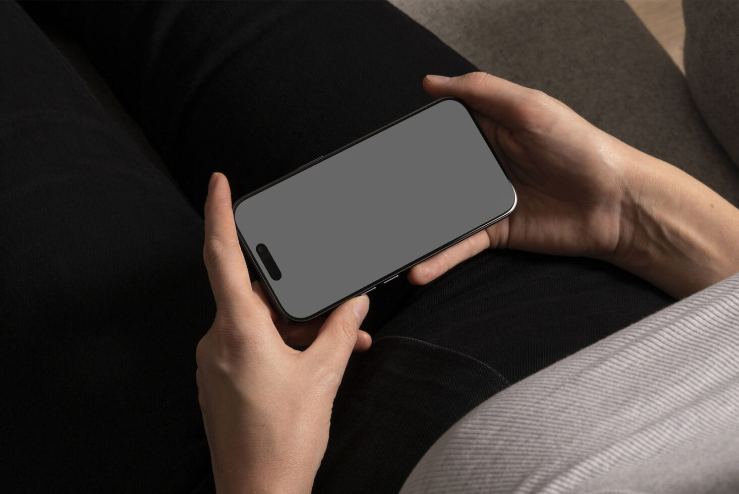 Smartphone mockup in hands showcasing a blank screen suitable for app design presentations and UI projects, ideal for designers seeking realistic visuals.