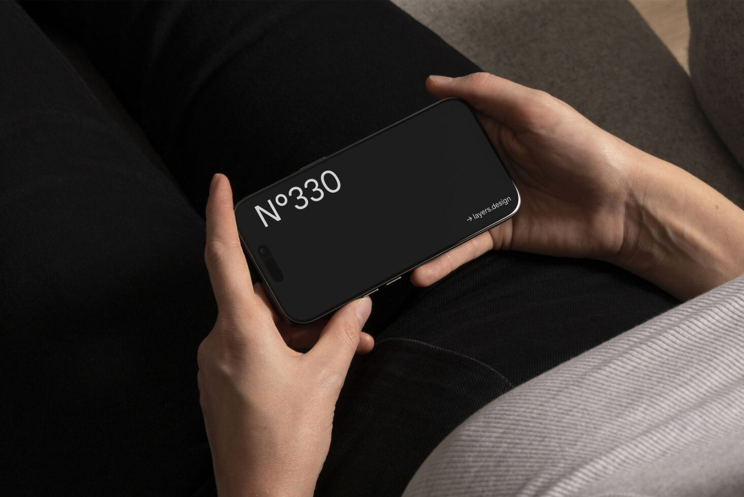 Person holding smartphone showing a mockup with text No330 and layers design on screen perfect for designers digital assets graphics templates resources.