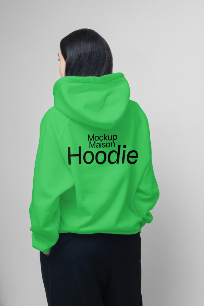 Back view of person in green hoodie. Hoodie mockup template for designers. Casual fashion apparel showcasing branding potential. Graphic design asset.