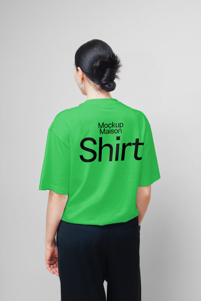 Back view of person in green t-shirt with bold black text great for fashion mockup hoodie template showcases design simplicity and modern streetwear style.