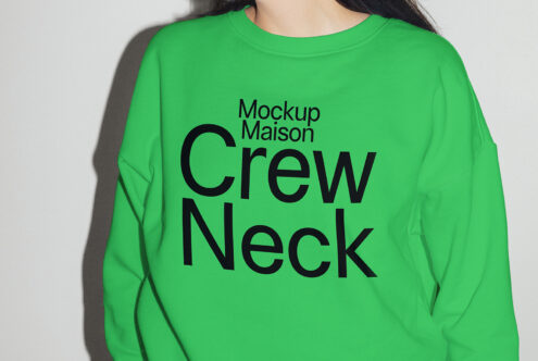 Green crew neck sweatshirt mockup with bold black text Mockup Maison designed for apparel templates, ideal for graphic and fashion designers.