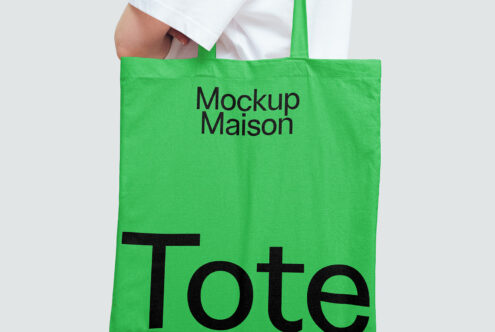 Green tote bag mockup with bold black text Mockup Maison ideal for showcasing branding designs. Perfect for designers creating product presentations.