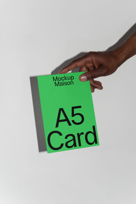 Hand holding an A5 card mockup against a white background features bold black typography Ideal for graphic design assets branding templates mockups