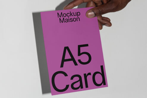 Hand holding a purple A5 card mockup for designers showcasing print design presentation branding templates stationery layout minimalist style.