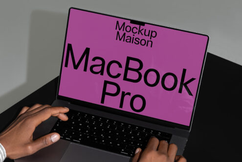 MacBook Pro mockup featuring a hand typing. Pink screen. Digital asset for designers. Ideal for showcasing applications and website templates.