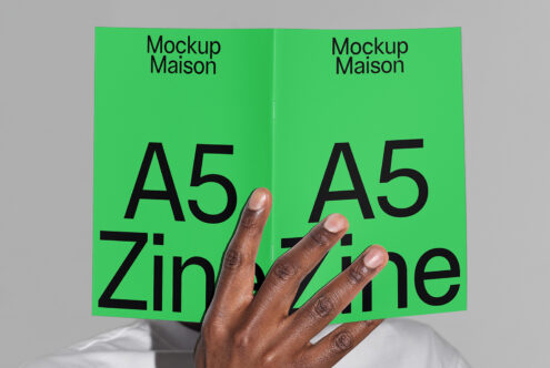 A5 zine mockup with a bright green cover held by hand. Ideal for showcasing zine design templates for designers. Modern, minimalist layout.