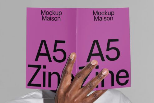 A5 zine mockup held by a person with a purple cover featuring bold black text. Ideal for design presentations templates and layout display for designers.