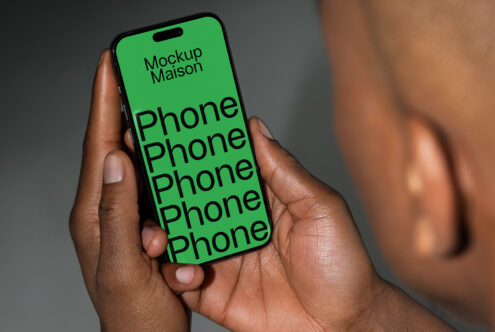 Phone mockup held in hands with green screen displaying text. Ideal for showcasing digital designs. Keywords: mockup, phone, template, graphic design.