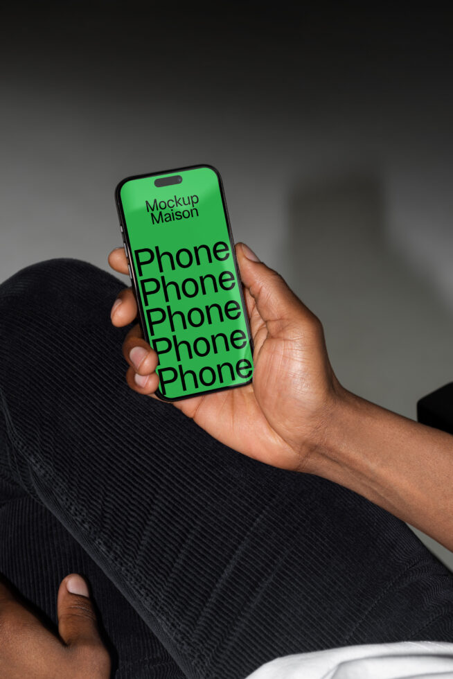 Mobile phone mockup in a hand showcasing a bold green screen for design presentation. Perfect for designers seeking modern templates and graphics.