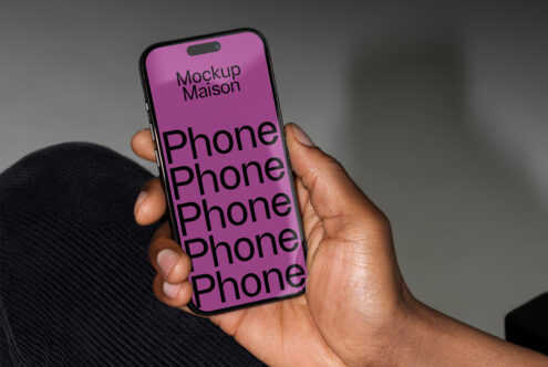 Smartphone mockup held in hand showcasing bold typography for designers. Ideal for creating app presentations or design showcases. Keywords: mockup, design.