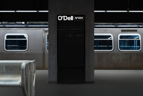 Subway station mockup featuring an advertisement display on a central column with a train in the background ideal for designers visualizing urban ad spaces.