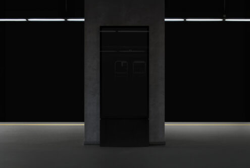 Modern interior subway station mockup featuring a blank vertical billboard on a dark wall. Ideal for showcasing graphics ads or promotional designs.