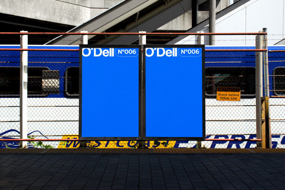 Two large blue O'Dell billboards mounted at transit station platform