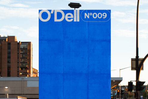 Large blue billboard mockup in urban setting for designers featuring bold typography O'Dell 009. Perfect for showcasing branding templates and graphics.