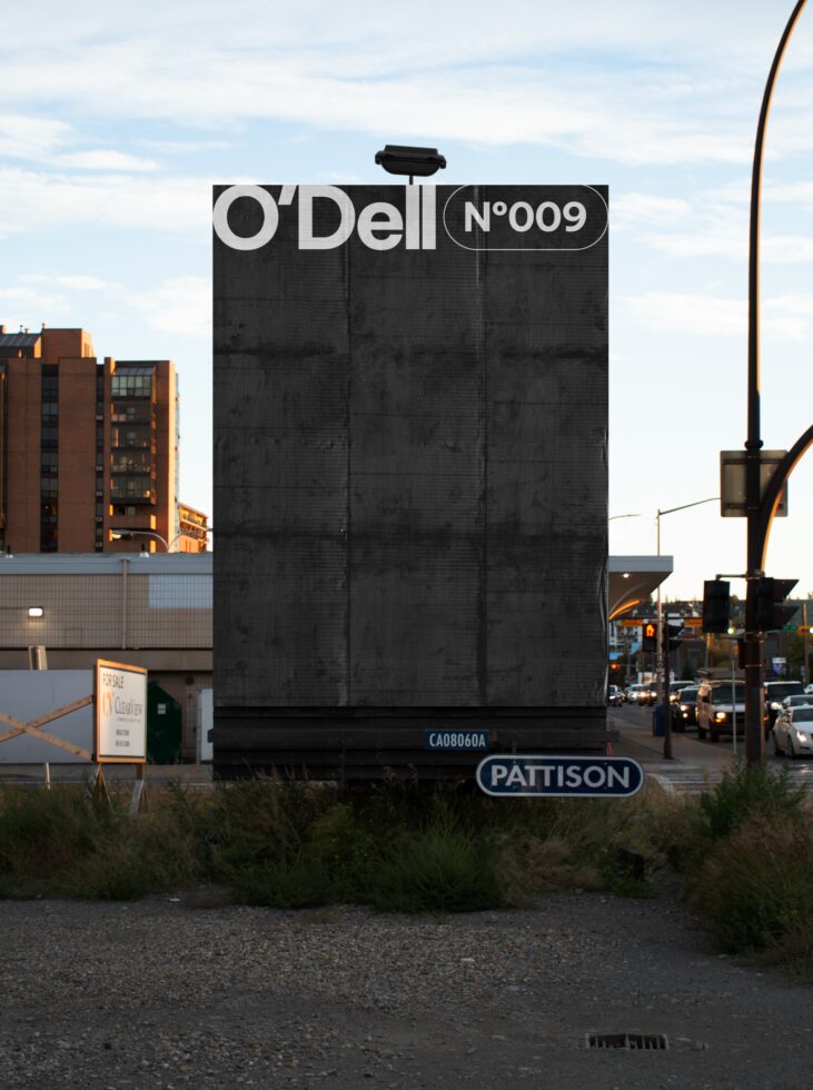 Urban billboard mockup displaying O'Dell Nº009 design in a city setting with buildings and traffic, ideal for showcasing marketing templates for designers.