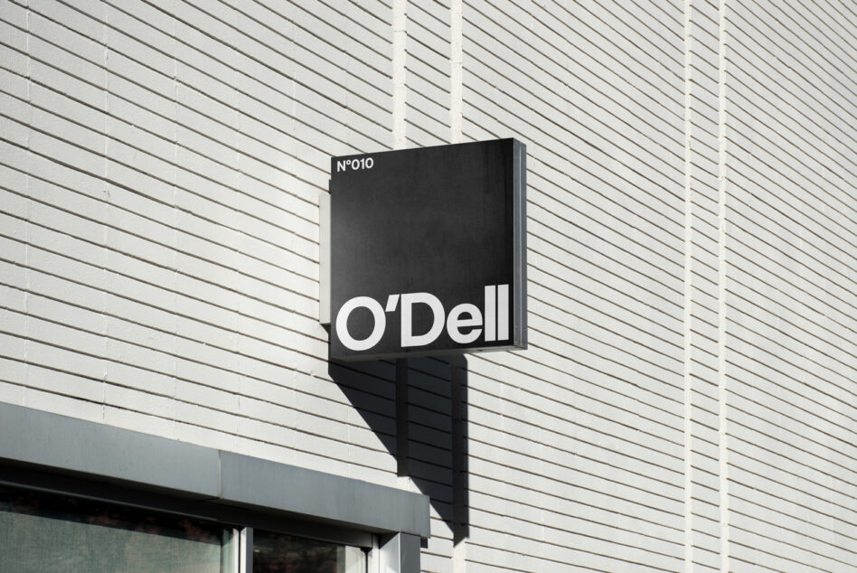 Mockup of a modern black wall sign on a stylish brick facade perfect for branding presentations and visual identity design projects by designers.