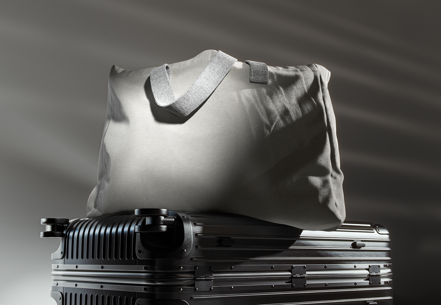 Minimalist mockup of a black suitcase topped with a gray fabric tote bag, ideal for travel-themed graphic design projects and product presentations.