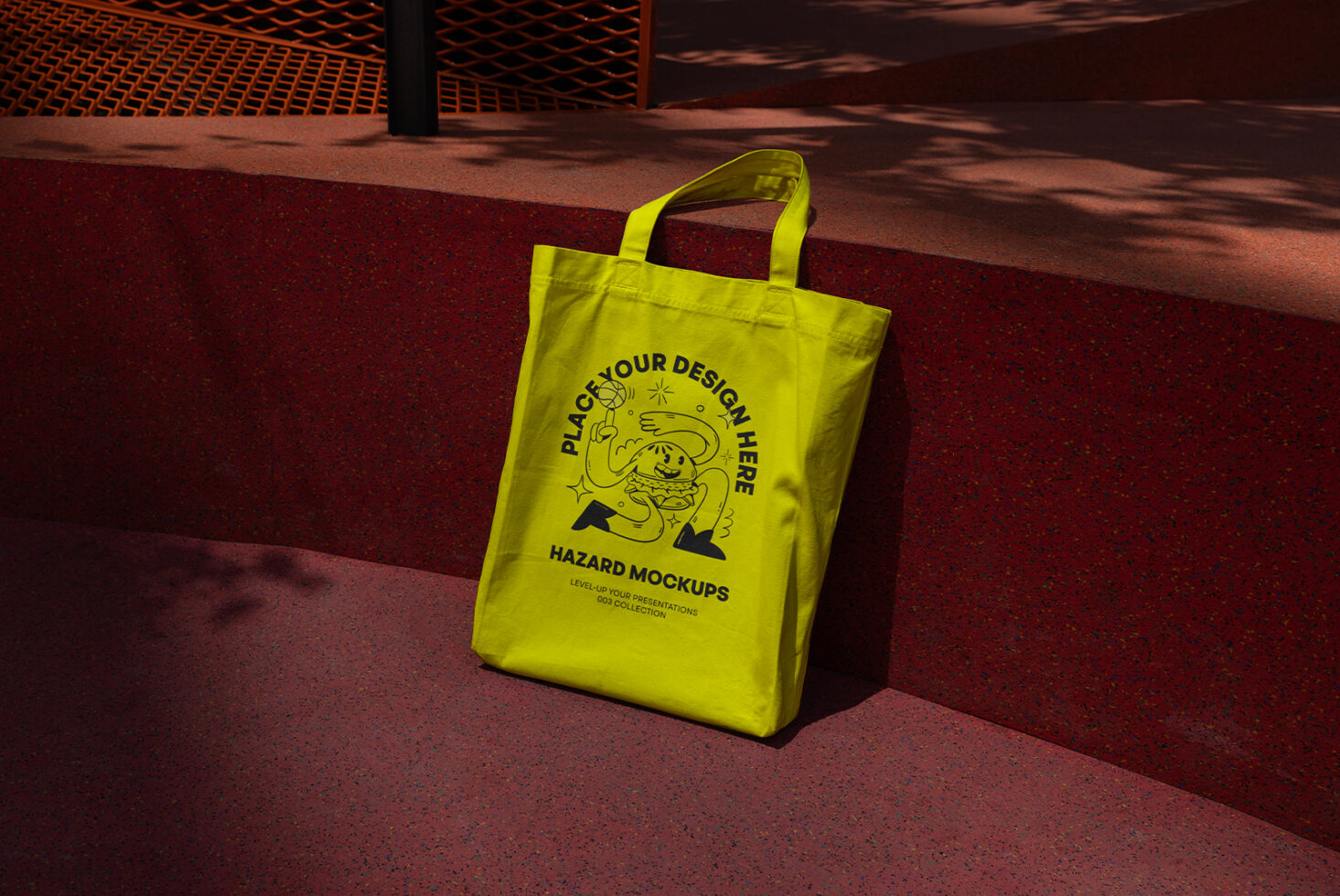 Yellow tote bag mockup on a red textured surface ideal for design presentations and showcasing graphics templates for designers and creatives.