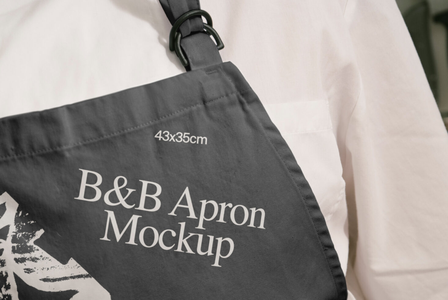 Close-up of a dark gray apron mockup with text B&B Apron Mockup 43x35cm on fabric ideal for designers product templates fabric design ideas.