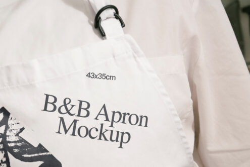 Close-up of a white apron mockup with branded text and adjustable strap. Perfect for designers seeking realistic garment templates for presentation.