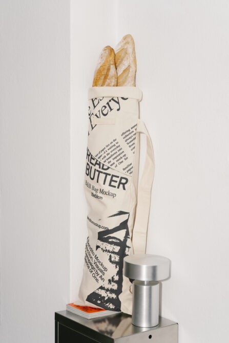 Cream bread bag mockup holding baguettes on shelf with metal container