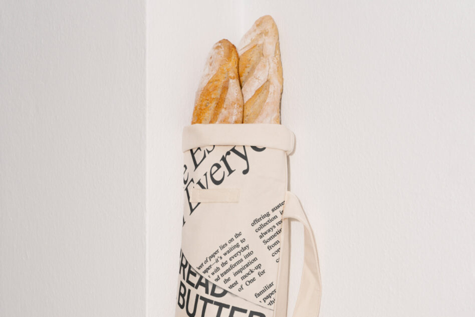 Cream bread bag mockup holding two baguettes with dark text overlay