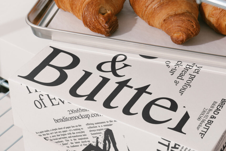 Cream bread butter box mockup with serif typography next to croissants on tray