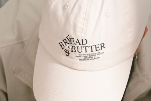 Baseball cap mockup with Bread and Butter logo in black text on beige fabric ideal for apparel branding design PSD resources for graphic designers