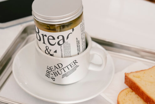 Bread and Butter jar mockup in a cup on a tray with sliced bread, perfect for branding presentations and packaging design templates for designers.