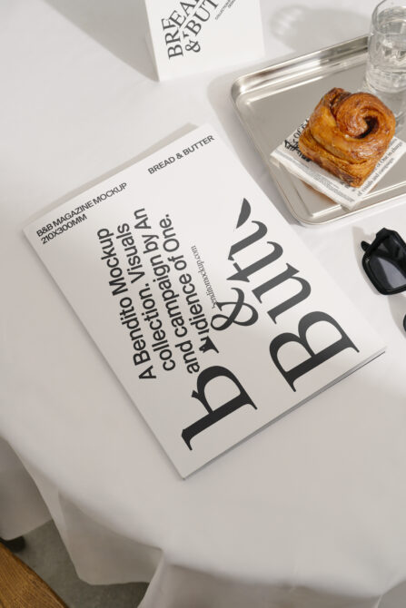 B&B magazine mockup styled on white cloth with pastry tray, glass, dark cover layout