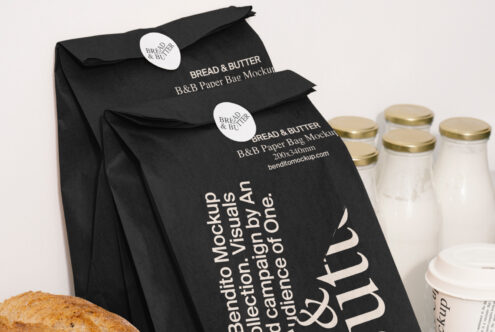 Black paper bag mockup for product packaging design featuring Bread and Butter branding next to milk bottles ideal for creative branding projects.