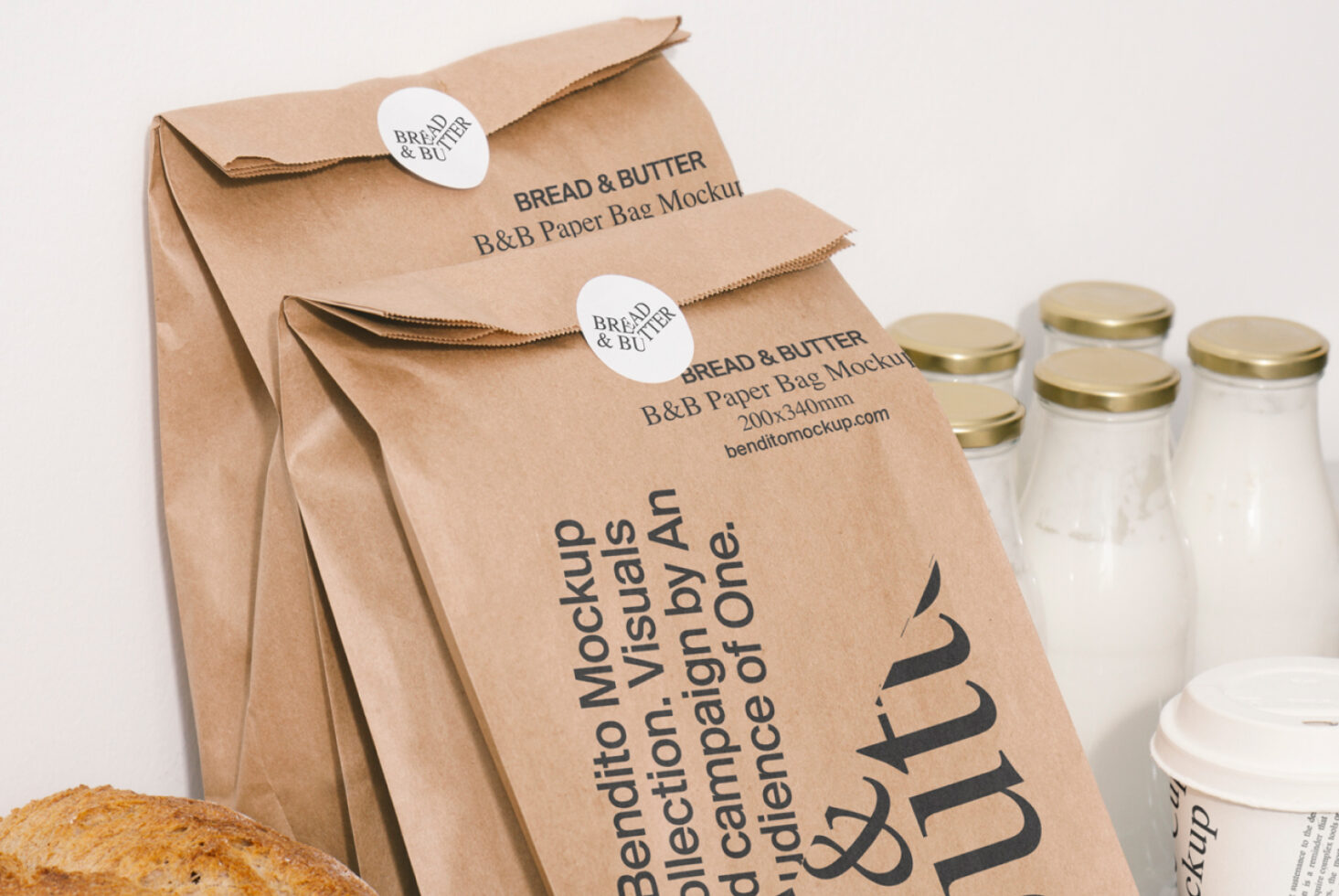 Mockup of brown paper bags with Bread and Butter branding, ideal for designers. Includes milk bottles in background for realistic presentation.