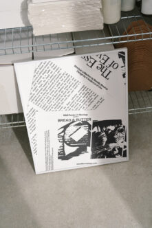 White version of B&B Poster 01 40x60cm mockup displayed at angle on wire shelving unit