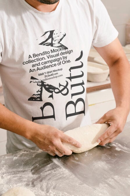 Guy in white shirt kneading dough, B&B Butito design printed on chest