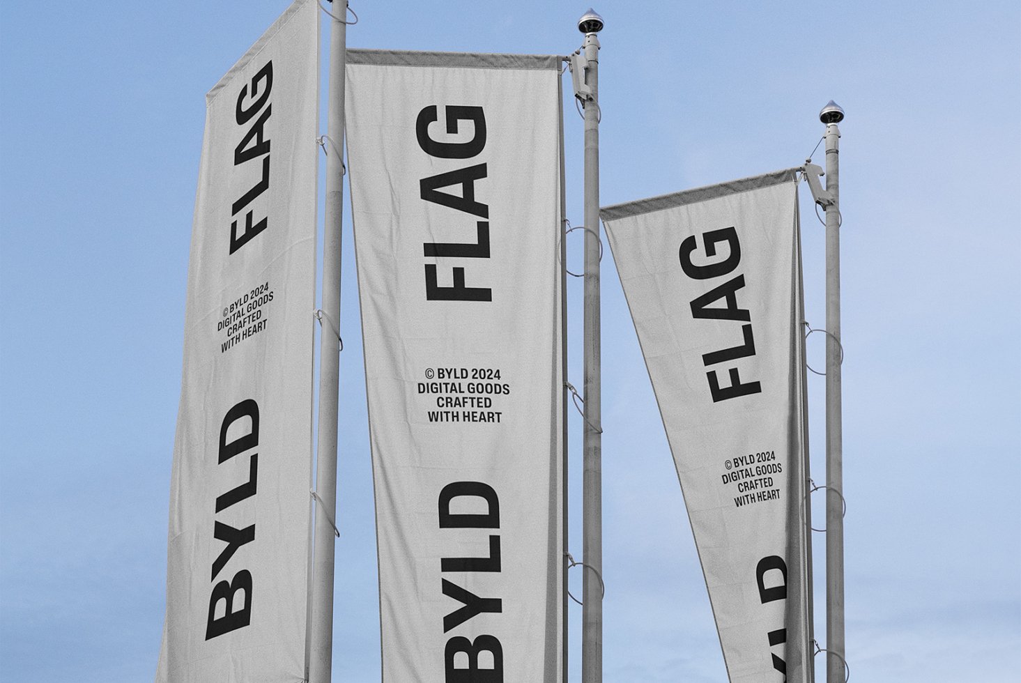 Three vertical banners with text BYLD FLAG against a blue sky. Ideal for outdoor advertising mockups. Keywords: graphic design, banner, template, mockup.
