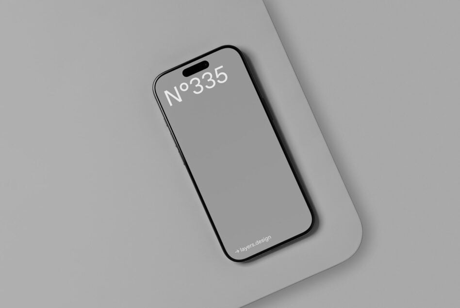 iPhone 14 Pro mockup centered on light gray surface, overhead shot