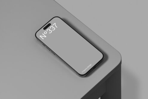 Smartphone mockup on sleek gray surface perfect for digital asset design, templates, and graphics. Ideal for showcasing mobile app interfaces.